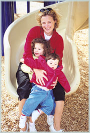 Mom and kids on playground slide